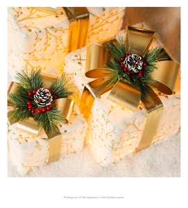 Macro view of white faux fur Christmas gift boxes with pine cones and LED warm lights