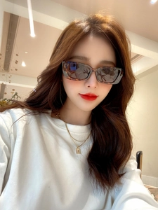 Close-up of stylish rectangular tortoise shell sunglasses worn by a fashion model