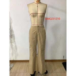Close-up of khaki cargo pants with functional large flap side pockets and high waist