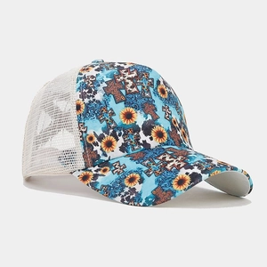 Detail of blue ponytail trucker hat featuring sunflower print and breathable white mesh