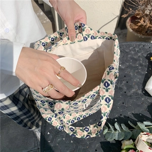 Detail view of corduroy floral tote bag with canvas lining and internal pocket