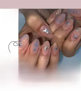 Close-up of pink and blue gradient press-on nails with silver stars and fluid metallic patterns