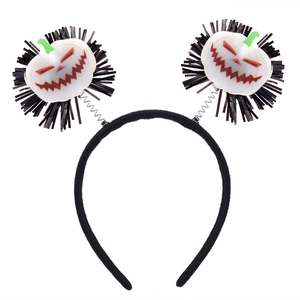 Detail of Halloween headband with white pumpkin motifs and black fringe on springs