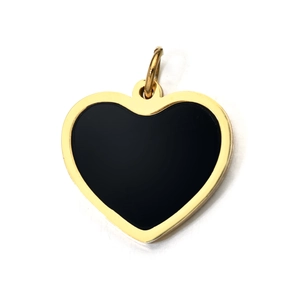 Detailed close-up of a heart-shaped pendant with black inlay and golden metal frame