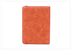 Detailed view of brown faux leather texture and precise stitching on the slim passport holder