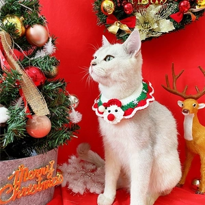 Detail of red and green Christmas pet collar with handmade Santa crochet on a cat