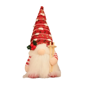 Knitted Christmas gnome with LED light and wooden ski poles on white background