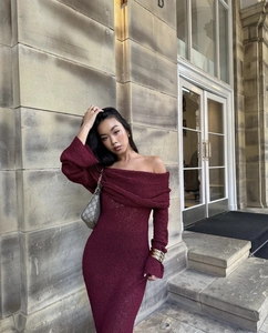 Close-up of elegant off-shoulder long sleeve knitted dress in burgundy red color
