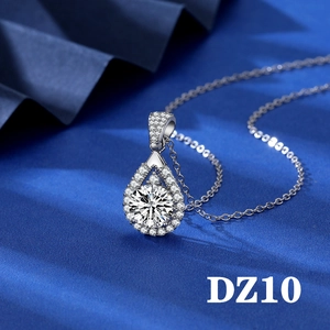 Macro detail of pear-shaped 2ct zircon pendant on dark blue silk fabric background