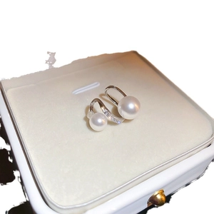Elegant bow zircon and pearl earrings presented in a white jewelry box