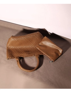 Detailed view of brown woven leather tote bag with matching inner zipper pouch set