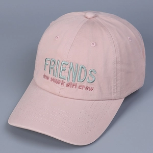 Detailed view of pink cotton baseball cap featuring green Friends embroidered lettering