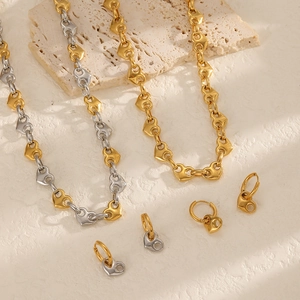 Detailed view of heart-link necklace and earring set in dual-tone gold and silver finish