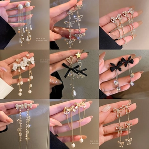 Elegant long tassel earrings with pearls, rhinestones, and ribbons in gold and silver