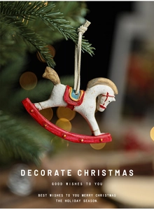 Macro shot of a vintage resin rocking horse ornament hanging on a Christmas tree