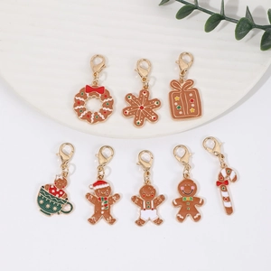 Macro shot of 9 assorted Christmas enamel charms with gold lobster clasps and festive shapes