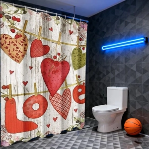 Detail of vintage heart pattern shower curtain with LOVE print and metal hooks