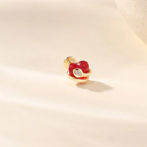 Macro detail of S925 silver stud earring with red heart gemstone and small zircon inlay
