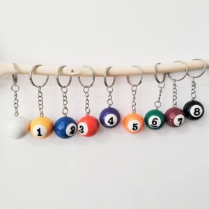Set of eight billiard ball keychains showing numbers 1 to 7 and a white cue ball
