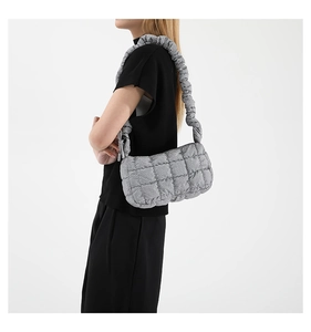 Detail of silver puffy quilted cloud bag with pleated strap and bubble texture