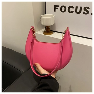 Detail of vibrant rose red crescent shoulder bag with smooth PU leather and gold hardware
