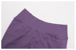 Detail of high-waisted ribbed waistband on purple seamless scrunch yoga leggings