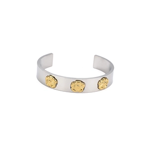 Minimalist stainless steel open bangle featuring three golden floral accents on silver finish