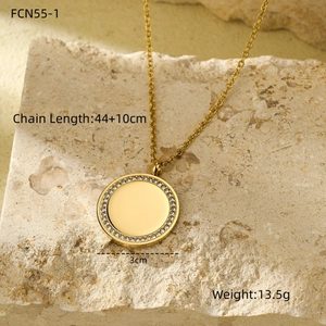 Detailed view of gold circular pave diamond necklace on a natural stone base