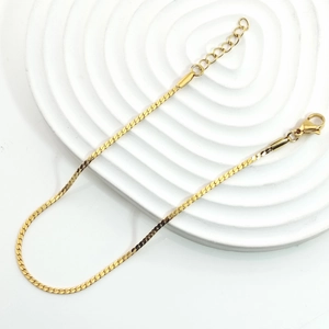 Detailed view of golden flat snake chain with lobster clasp and adjustable extension