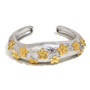 Exaggerated silver stainless steel open bangle featuring 18K gold-plated floral accents