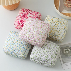 Quilted floral sanitary napkin storage bags in five pastel colors with zipper closure