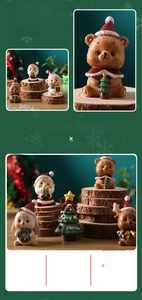 Detailed view of hand-painted resin Christmas figurines with a miniature Xmas tree