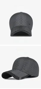 Detail of dark grey winter baseball cap with diamond quilted stitching and metal logo