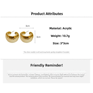 Detailed view of chunky golden C-shaped hoop earrings with unique hammered texture and silver pins