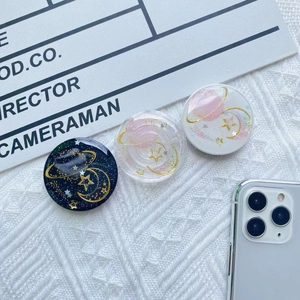 Macro detail of epoxy resin celestial phone sockets with stars and moon on lace