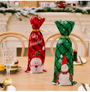 Details der rot-grün karierten Weinflaschenhüllen mit Weihnachtsmann- und Schneemann-Motiv