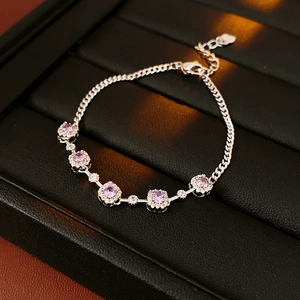 Close-up of silver chain bracelet featuring five light purple square-cut cubic zirconia