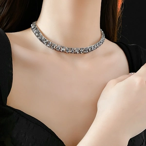 Detail of silver rhinestone choker necklace worn by a model showcasing sparkling crystals