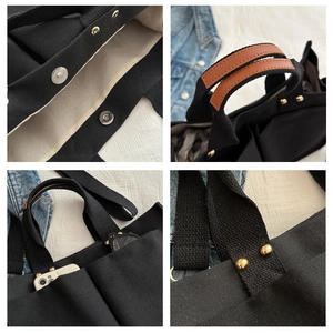 Détails du grand sac cabas noir en toile avec rivets dorés et poignées en cuir marron