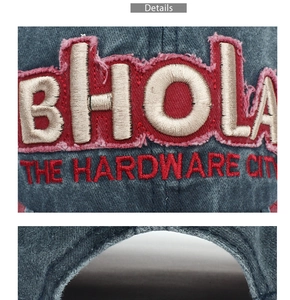 Detail of BHOLA 3D embroidery on washed navy denim baseball cap with vintage finish