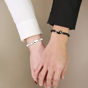 Macro shot of Yin Yang bead bracelets for couples featuring white marble and black beads