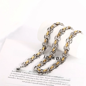 Close-up of two-tone Byzantine chain necklace in gold and silver stainless steel