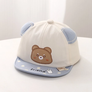 Close-up of baby sun hat featuring 3D ears, bear embroidery, and blue polka dot brim