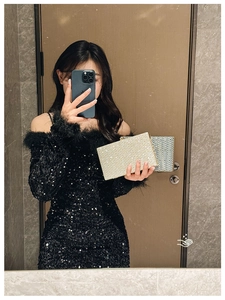 Chic acrylic clutch bag with chevron pattern shown in an elegant evening outfit detail