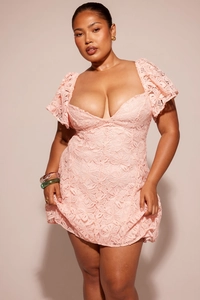 Detail of pink lace V-neck mini dress with elegant ruffle sleeves and floral textures