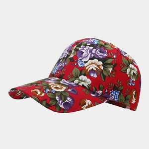 Side view of red canvas baseball cap featuring tropical floral prints and quality stitching