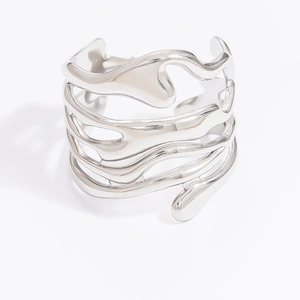 Close-up of silver multilayer wavy bangle in stainless steel with polished finish