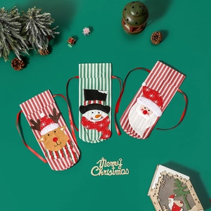 Three knitted Christmas drawstring gift bags with Santa, reindeer and snowman designs