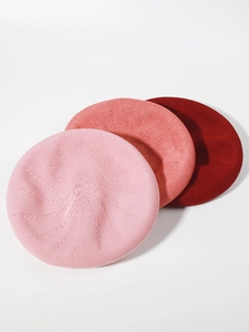 Detailed view of the fine knit texture on three shades of pink beret hats