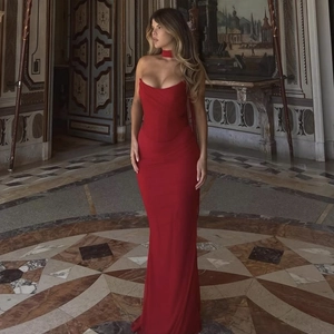 Close-up of red strapless evening dress with matching choker in a luxury palace hall